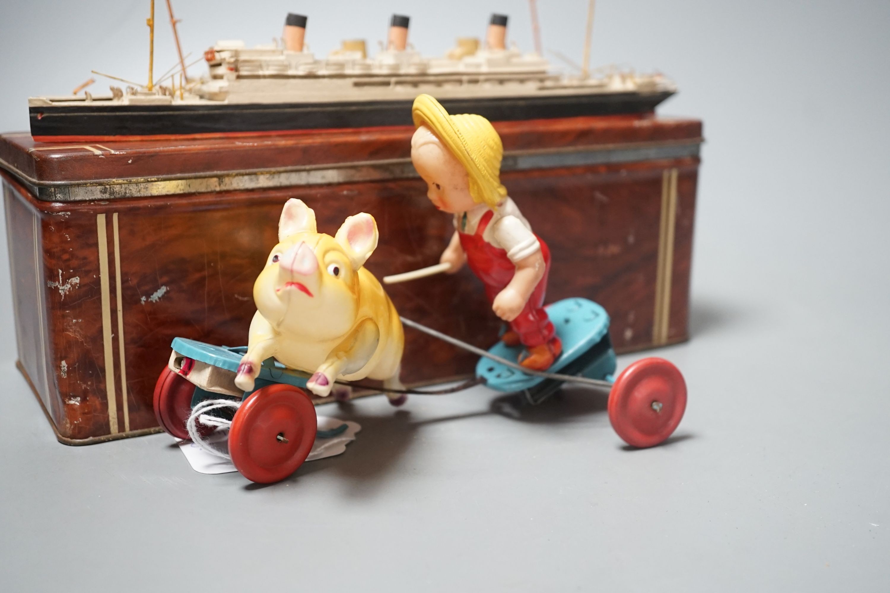 Bassett-Lowke Waterline Model Ships and a Japanned boxed celluloid ‘pig chaser’ toy, 9cms high.